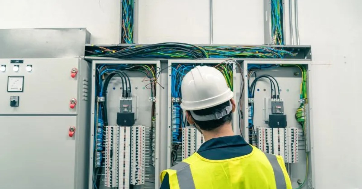 Electrician reviewing residential electrical work